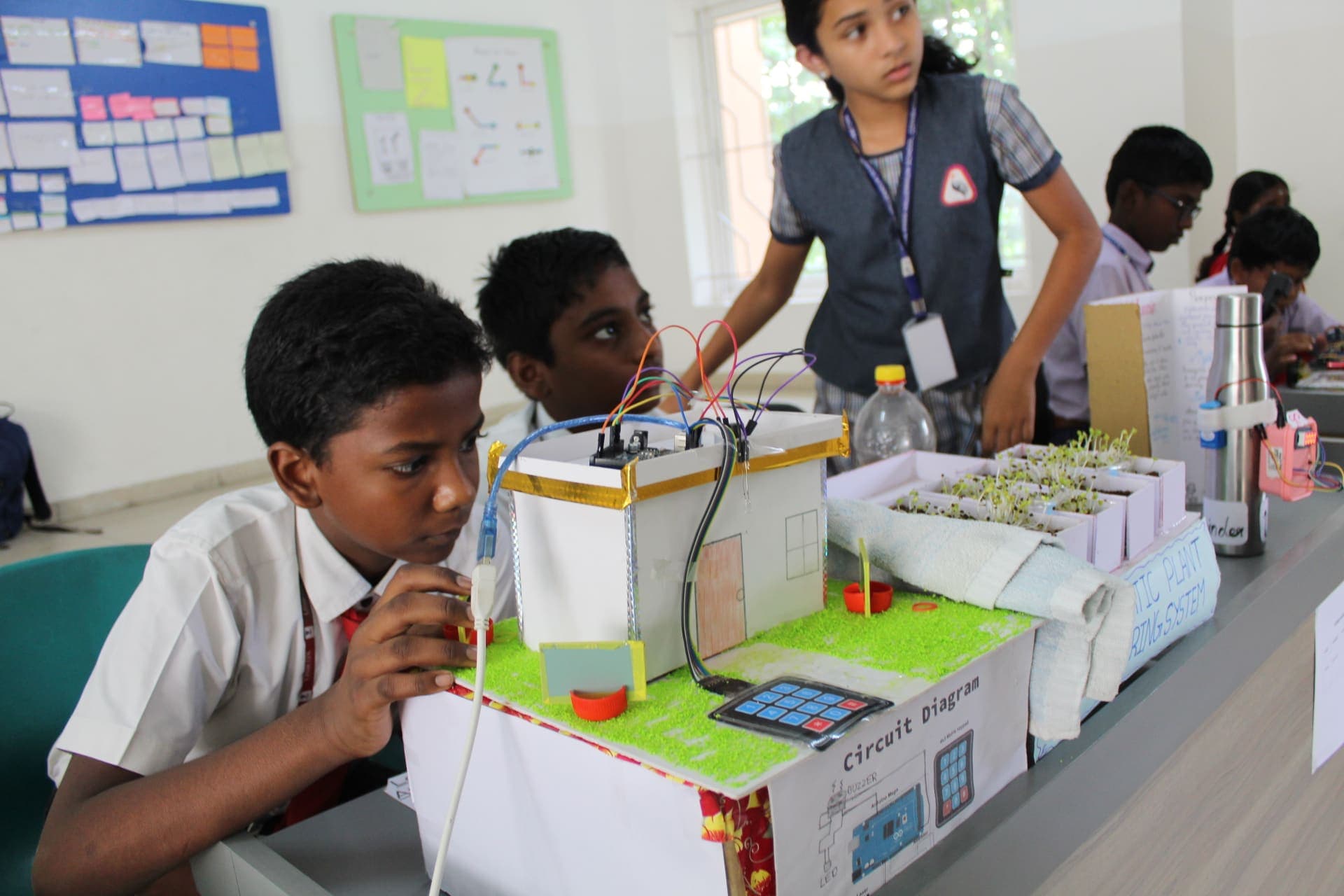 Judges reviewing a student innovation at YSF